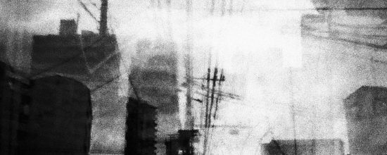 Dark building silhouettes, a chimney and dense power lines against a bright grainy sky – double exposure, multiple exposure, n-fold exposure, superposition, 二重露光, 多重露光, n重露光, 重ね合わせ, 35mm black and white film, 辻, Stefan Paulus
